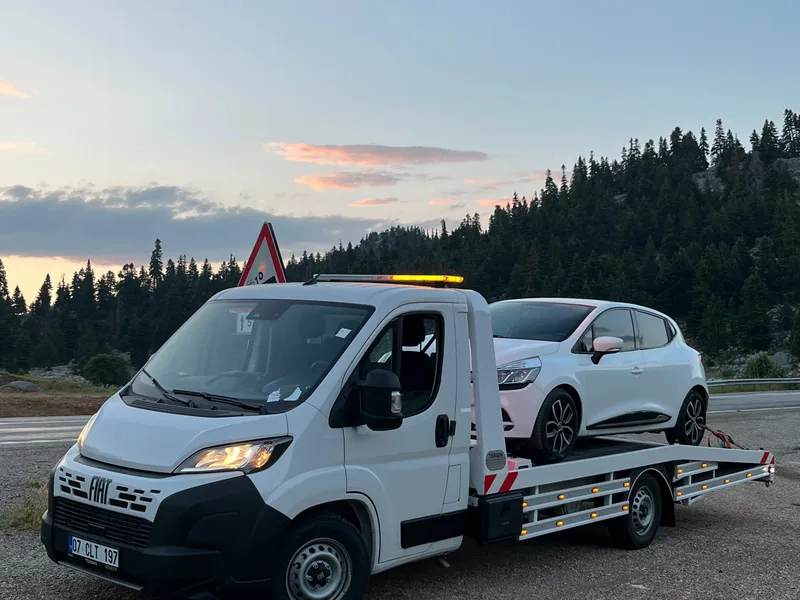 Şehir içinde beyaz otomobil taşıyan kurtarıcı